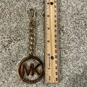 Gold finished Michael Kors bag charm. Great used condition.